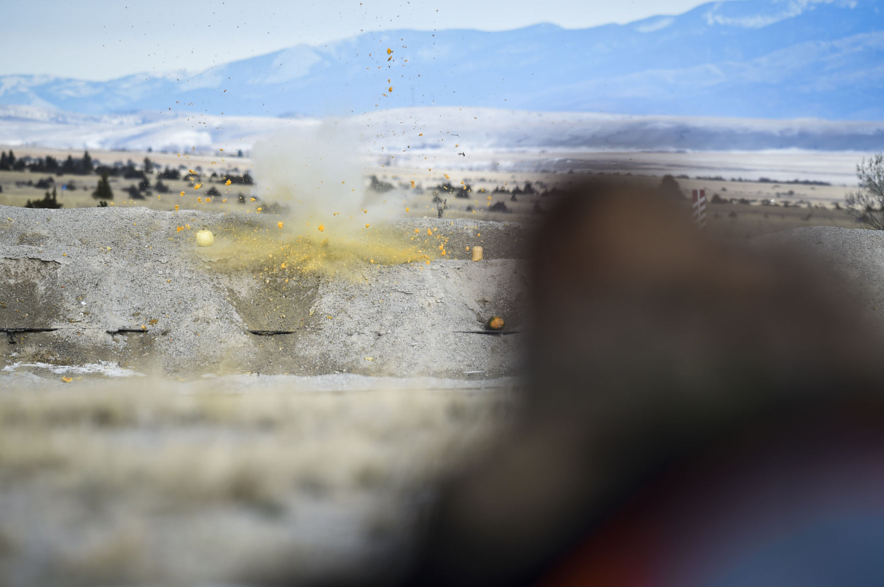 Tobey Peck, 11, right, shoots a Tannerite filled pumpkin Saturday causing it to blow chunks of pumpkin into the air down range.